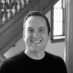 Steve Barcus smiles with a Bascom staircase in the background