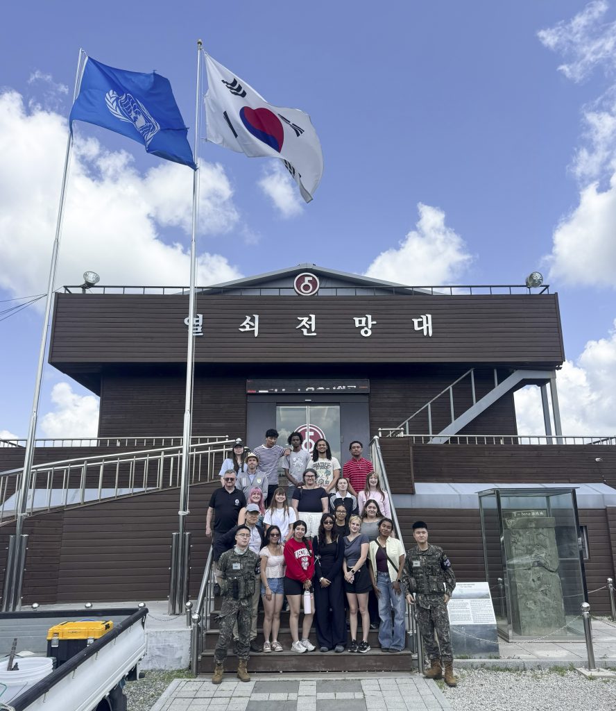 Students stand in front of an observation station.