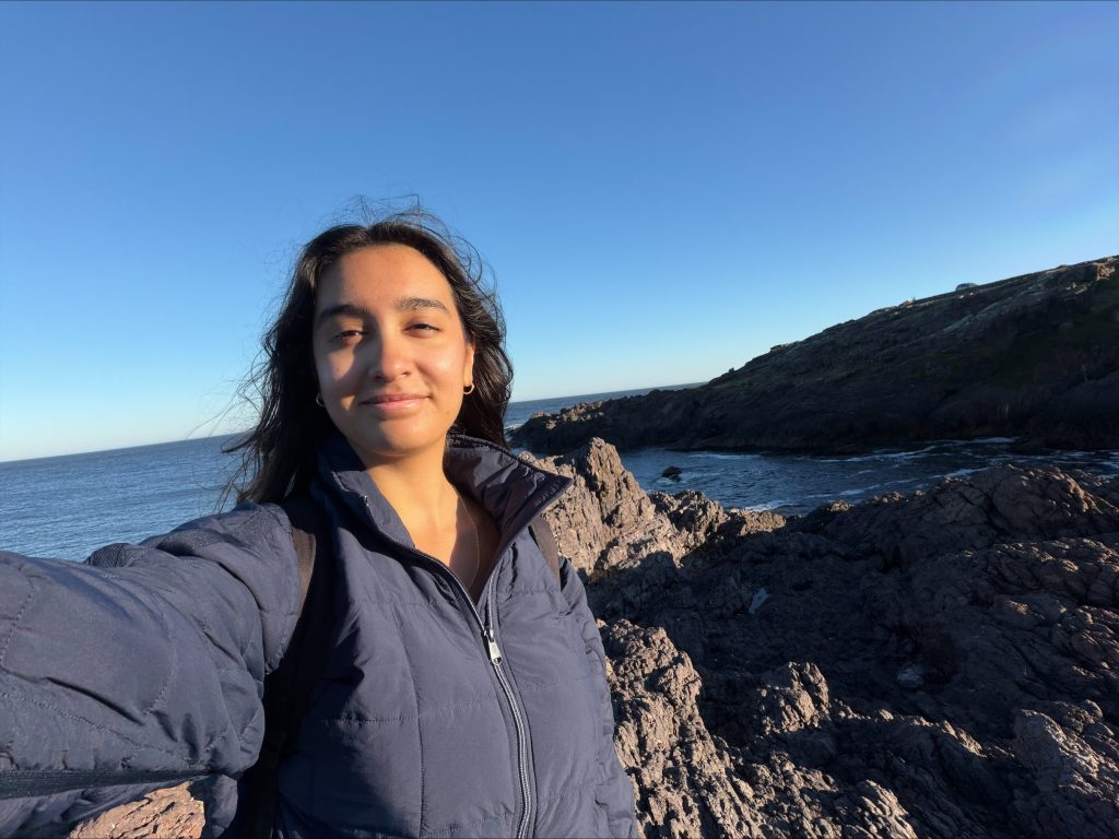 Maria Mulloy standing on a beach taking a selfie